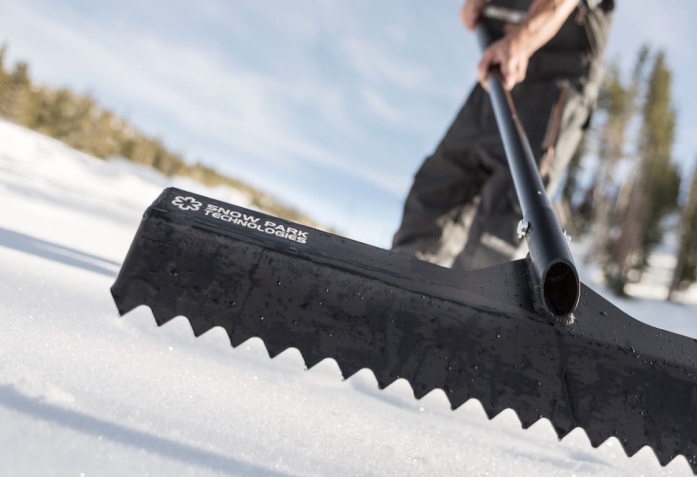 Hand-shaping a terrain park feature with a rake