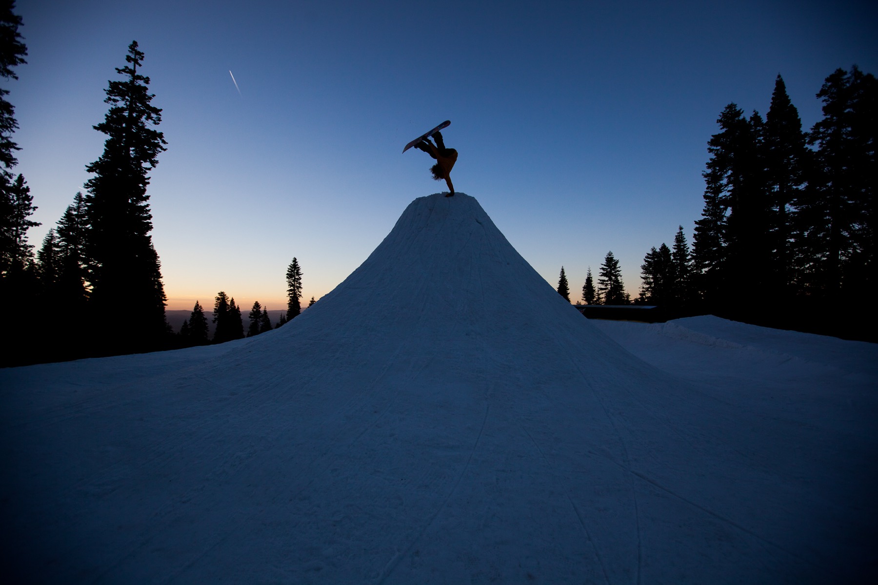 Rider launching off a jump at dusk